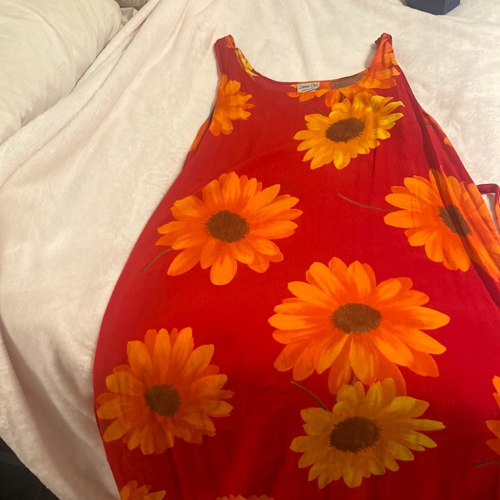 A maxi dress with Gold ,Orange and brown large flowers accenting the red!